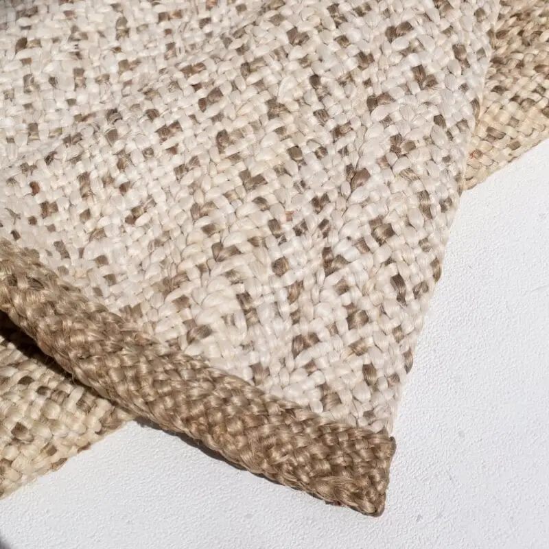 A hand-crocheted jute rug with a gradient color effect